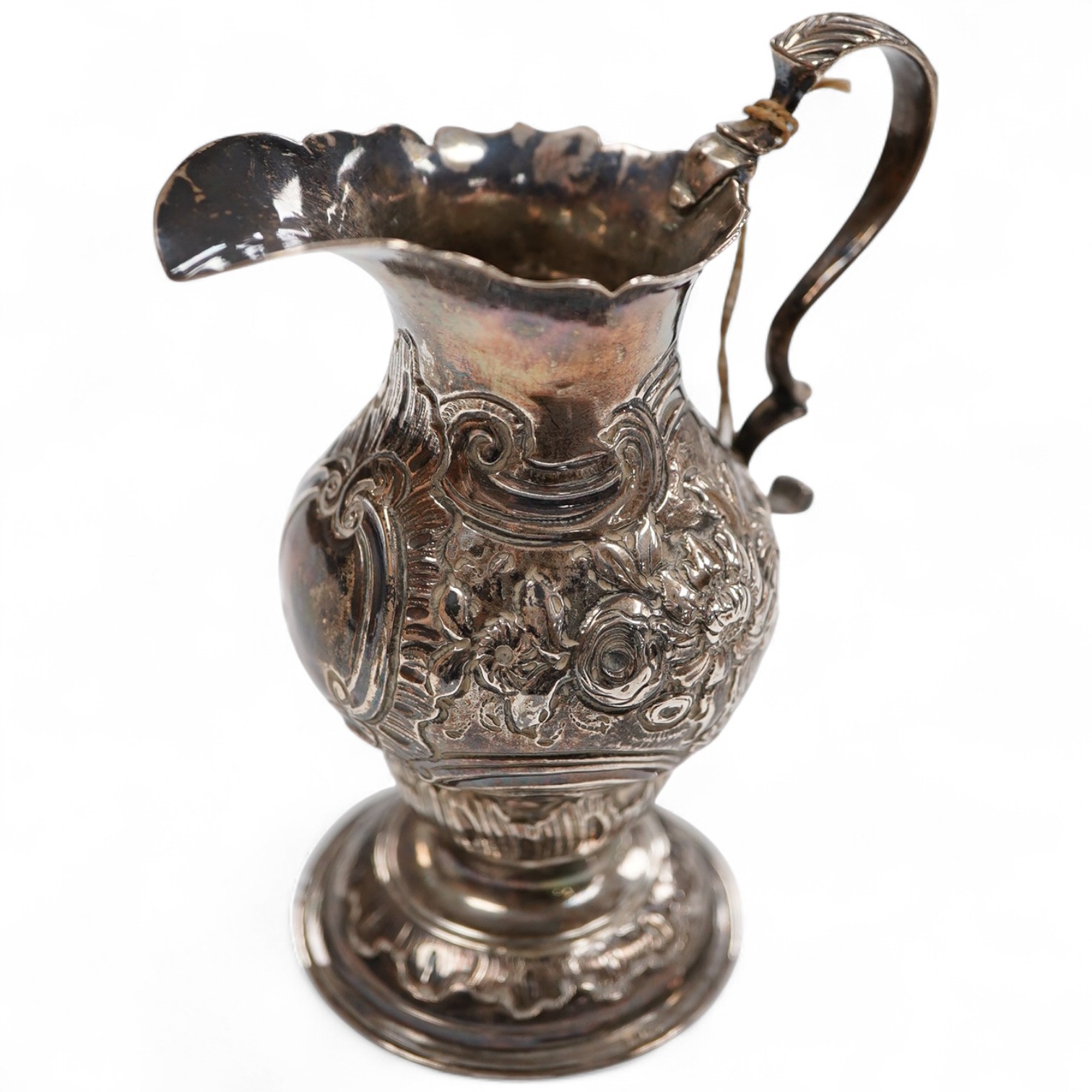 A George III silver inverted pyriform cream jug, with later embossed decoration, Charles Chesterman II, London, 1779?, height 11.4cm.